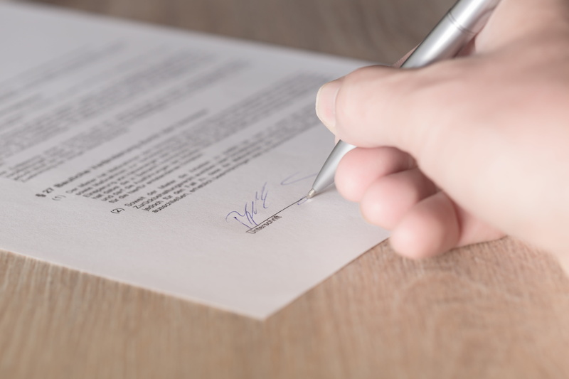 indoors, printing, hand, available, table, holding, business, selective focus, occupation, paper, text, writing, human body part, pen, document, person