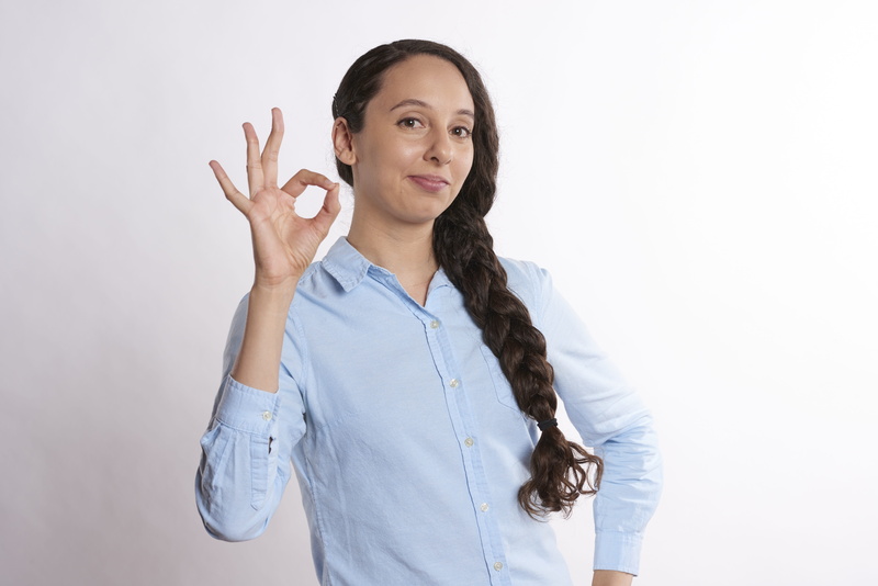 hairstyle, portrait, office, right, ok sign, women, sign, computer, isolated, business, ok, person, shirt, website, blue, front view, pointing right, hair