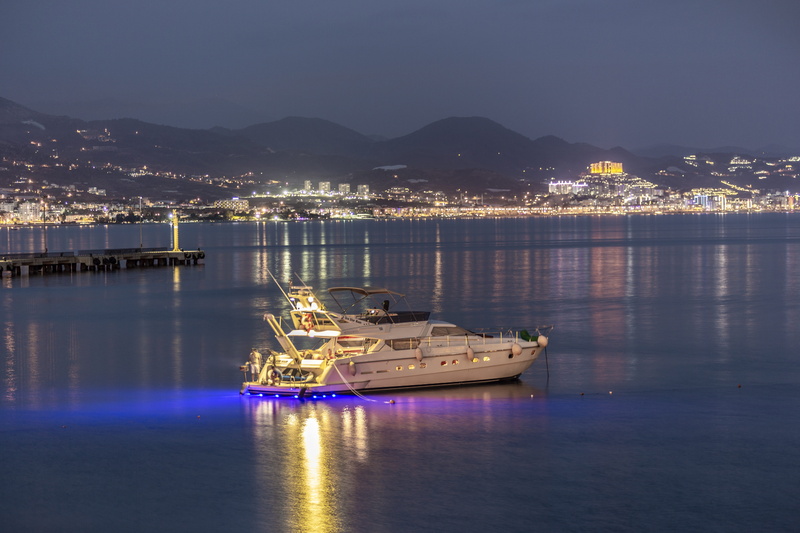 beach, passenger craft, no people, mountain range, sailboat, illuminated, waterfront, yacht, mode of transportation, outdoors, reflection, night, antalya