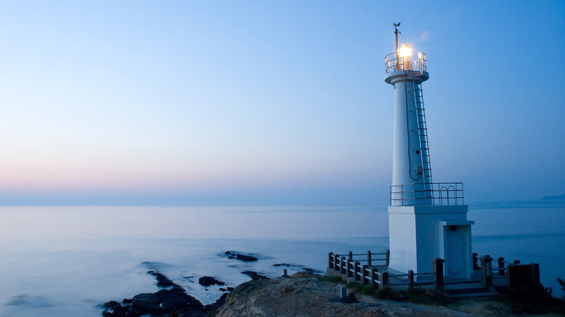 nature, horizon over water, dusk, tower, scenics - nature, horizon, beach, no people, outdoors, architecture, illuminated, landscape, lighthouse, built structure