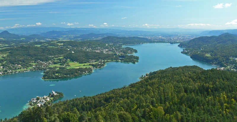 island, water, mountain range, non-urban scene, tranquil scene, high angle view, klagenfurt, waters, scenics - nature, peninsula, conifers, outdoors, mountain