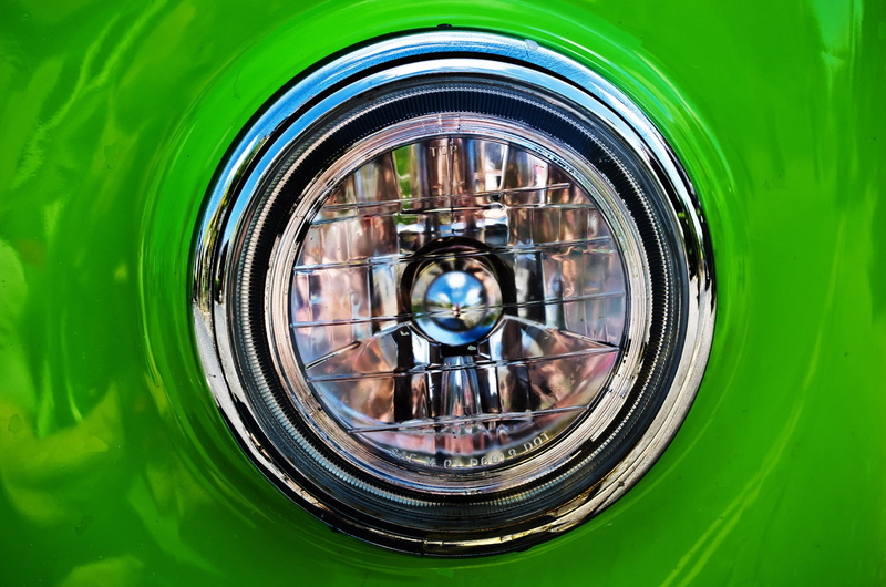 headlamp, light, metal, visibility, background, dark, no people, wheel, reflection, shape, chrome, shiny, indoors, multi colored, glass - material, geometric shape