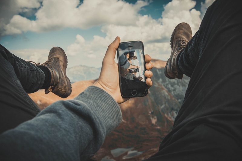 equipment, cloud - sky, digital camera, photography themes, view, electronics, reflection, mountains, photographer, screen, modern, people, casual clothing