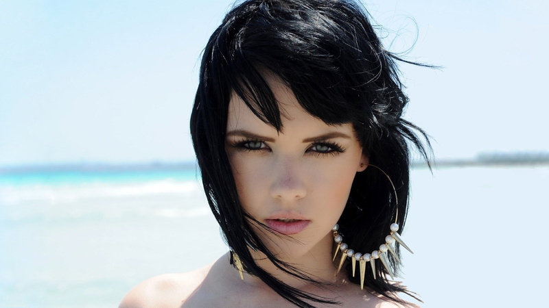 one person, black hair, headshot, portrait, lifestyles, hair, water, outdoors, beauty, sky, land, focus on foreground, hairstyle, beautiful woman, sea