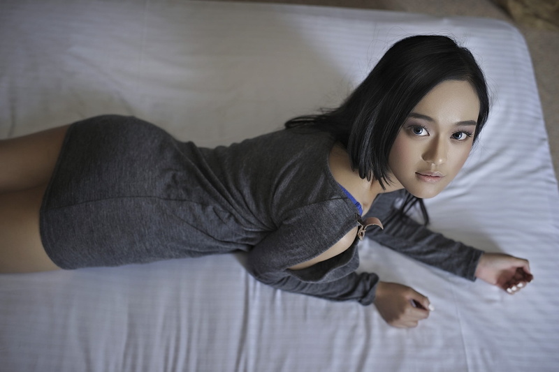 looking at camera, fake iris, leisure activity, long eyelashes, relaxation, women, gray dress, black hair, Asian, three quarter length, real people, portrait