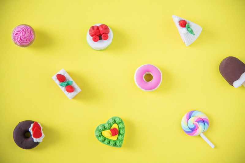 medium group of objects, unhealthy eating, candy, green background, still life, variation, delicious, collection, multi colored, temptation, closeup, cupcake