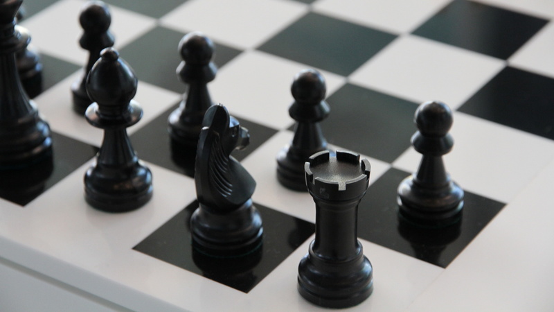chess board, strategy, high angle view, king - chess piece, leisure activity, board game, large group of objects, aggression, black color, indoors, success