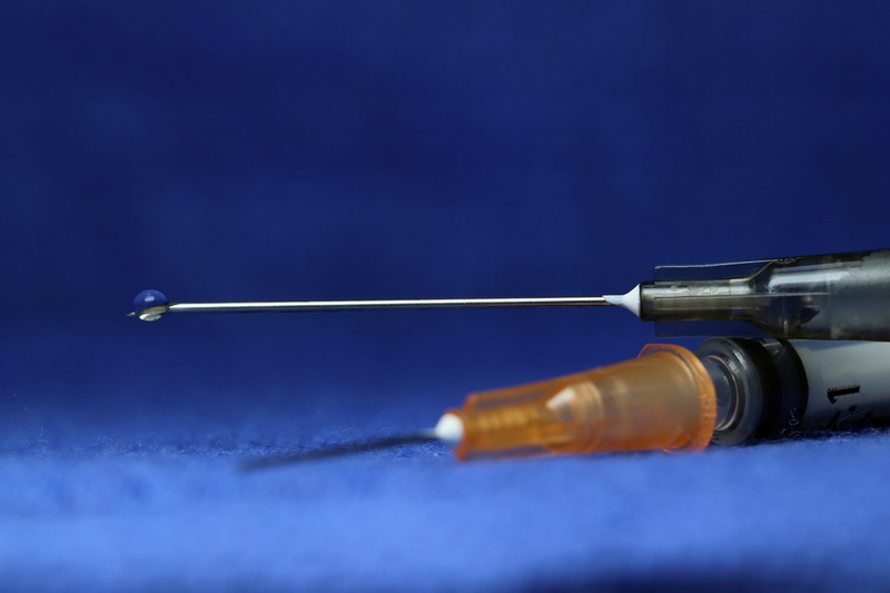 studio shot, 5K, single object, sharp, disease, injection, blue background, care, health, blue, healthcare and medicine, research, needle, treatment, selective focus