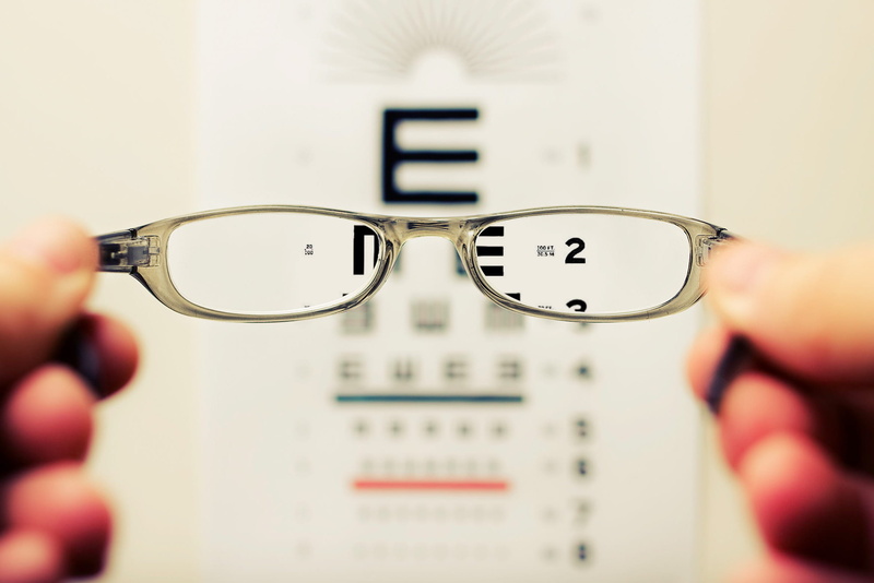 photography, indoors, focus, eye exam, eyesight, looking through an object, optician, close-up, glasses, healthcare and medicine, one person, glass, holding