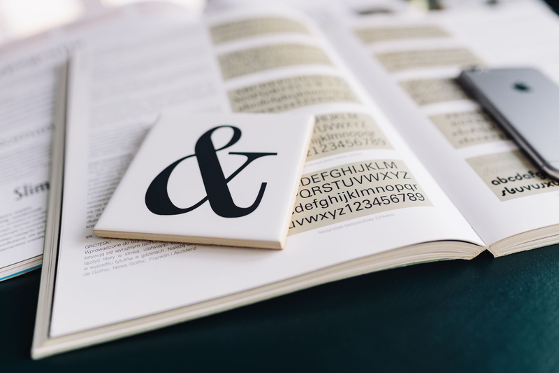 non-western script, indoors, day, letters, still life, education, page, text, document, high angle view, paper, western script, business, studio shot, Typography