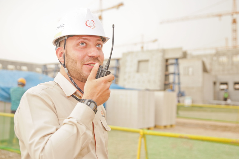 wearing, white, helmet, build, males, occupation, hardhat, hard, adult, way, architecture, woman, built structure, technology, looking, radio, hat, industry