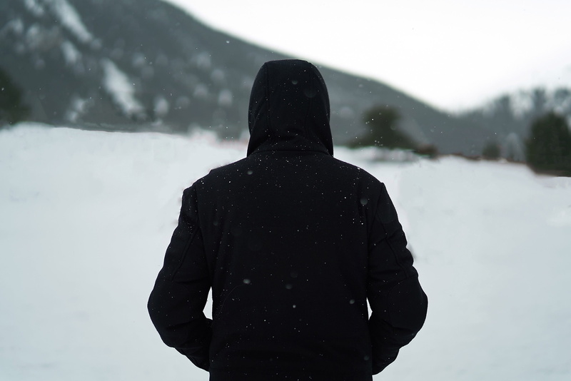 black, walking, daytime, man, shallow, waist up, looking at view, day, 2K, hood, hood - clothing, clothing, field, one person, leisure activity, rear view