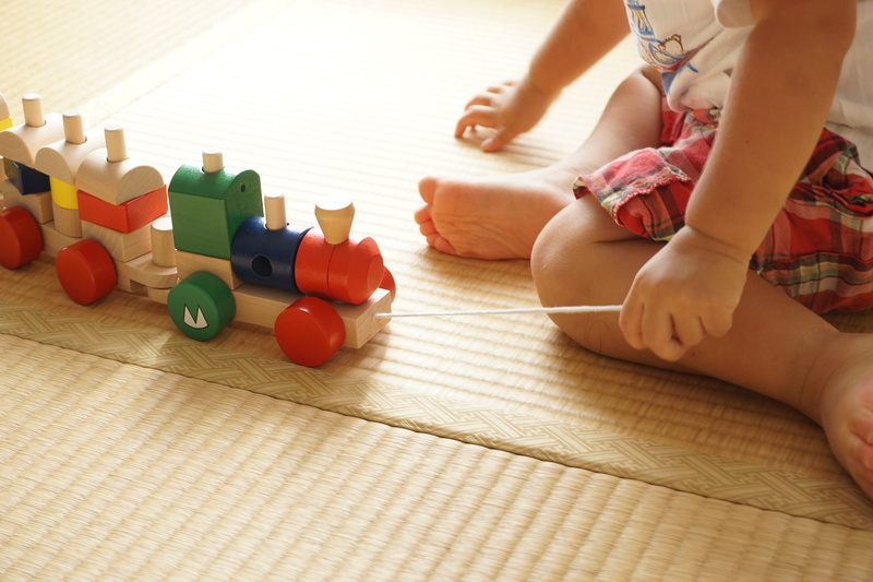fun, barefoot, white, human foot, boy, flooring, indoors, babyhood, one person, low section, color, hand, holding, home Interior, child, lifestyles, human leg