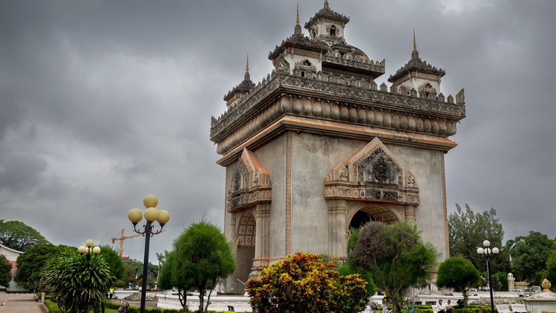 tree, architecture, history, building, patuxai, monument, outdoors, sky, built structure, gate, tourism, city, low angle view, travel, plant, laos, nature