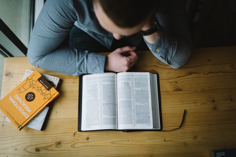 sitting, word of god, read, holding, man, jesu, paper, brown, wooden, man reading, scripture, men, front view, coffee shop, casual clothing, indoors, 5K