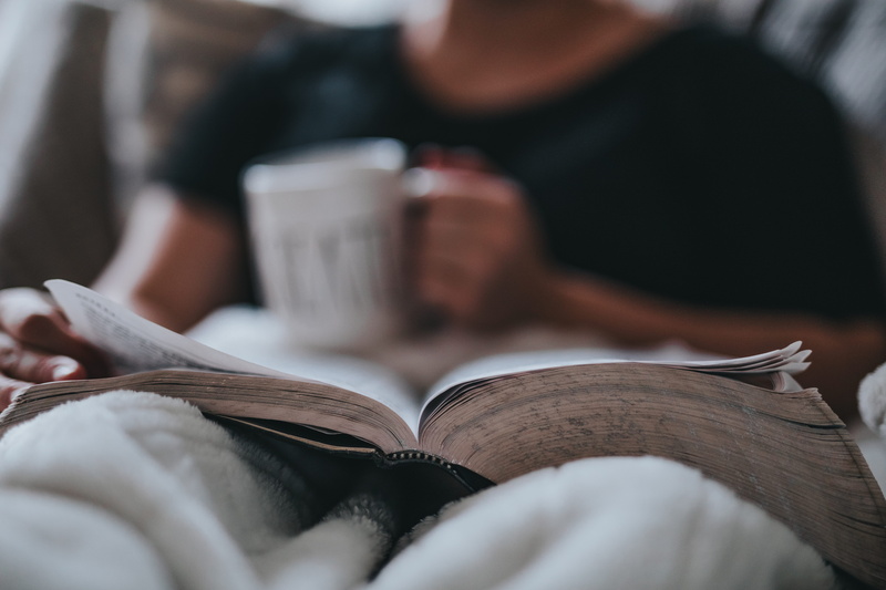 young adult, studying, relaxation, indoors, one person, white, mug, coffee, adult, 5K, book, sitting, midsection, paper, reading, learning, publication