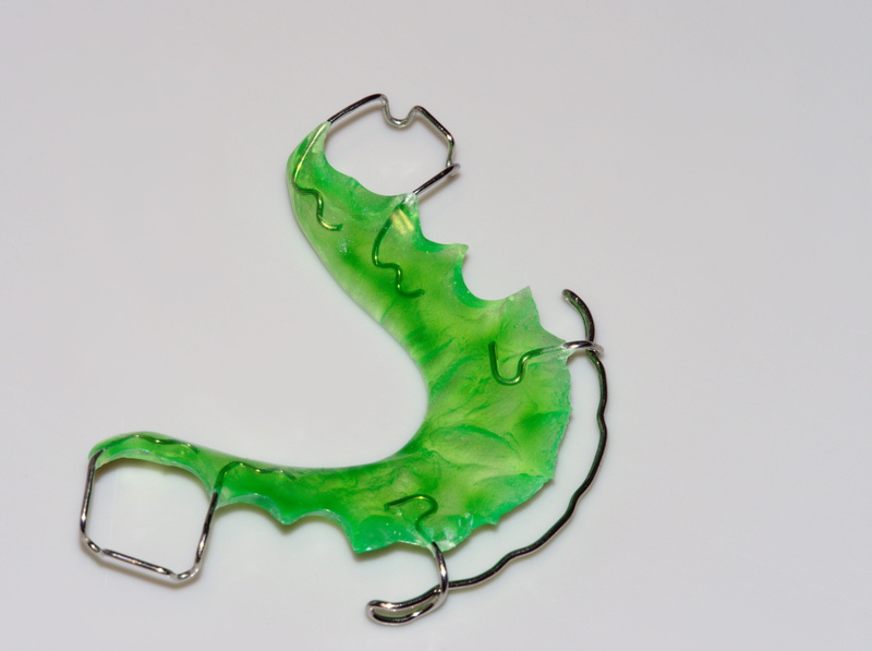 cut out, environment, close-up, braces, green color, obsolete, gray background, straightening teeth, side view, no people, design, diy, metal, creativity