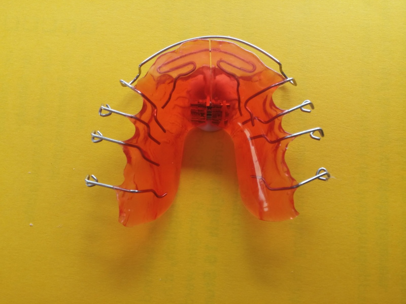 retainer, colored background, table, close-up, single object, high angle view, steel, close, Rail, seemed, orthodontic, metal, 4K, yellow background, yellow