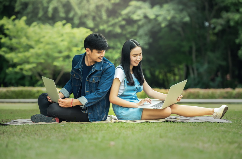 woman, technology, field, seat, young women, wireless technology, men, smile, sitting, young adult, using laptop, communication, malaysia, connection, grass