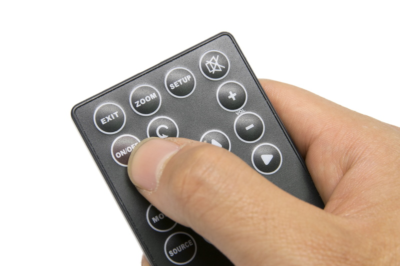 tv, cut out, indoors, one person, holding, adult, number, studio shot, human hand, hand, technology, human body part, human finger, keypad, finger, person