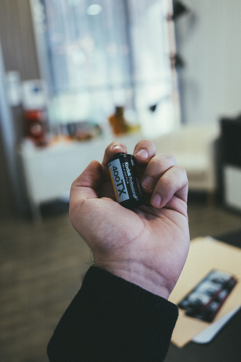 lighter, control, technology, close-up, indoors, watching tv, human, communication, human body part, real people, battery, computer, wood, focus on foreground