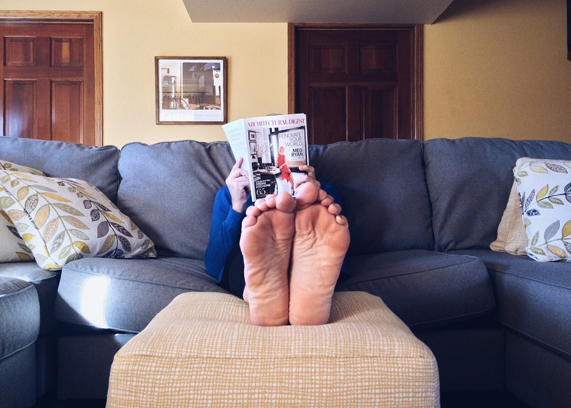 holding, domestic room, pillow, remote control, domestic life, leisure activity, home interior, comfortable, technology, person, sofa, relaxation, indoors