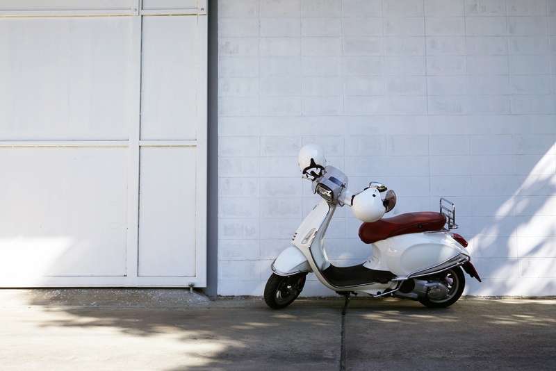 wall, sitting, scooter, mode of transportation, street, architecture, top, concrete, transport, outdoors, speed, adult, helmet, transportation, urban, white
