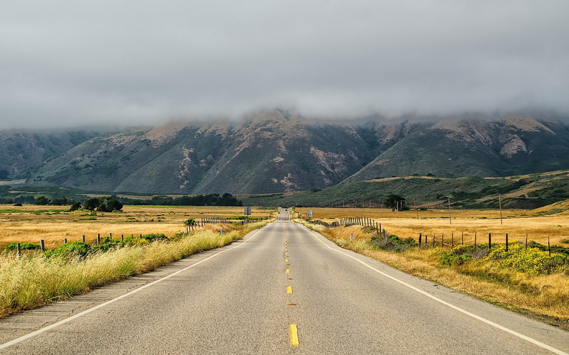 nature, transportation, sign, symbol, sky, mountain range, outdoors, land, vanishing point, dividing line, the way forward, straight, environment, cloud - sky