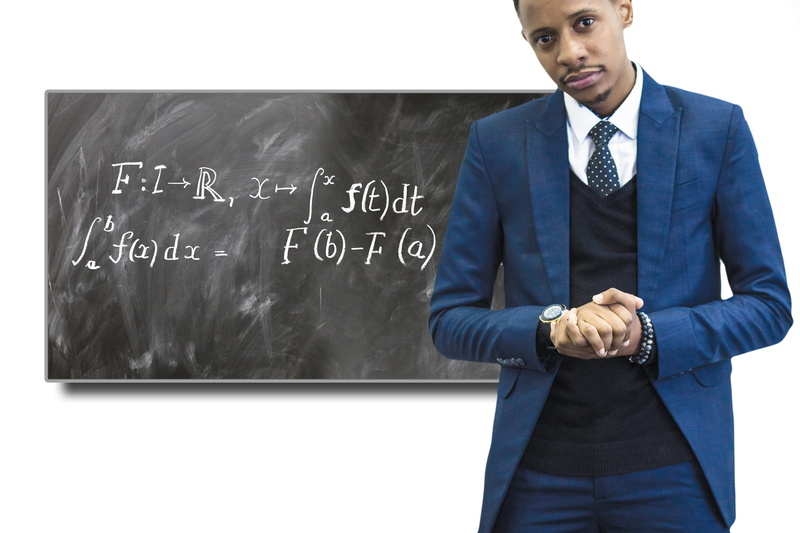 one person, three quarter length, blackboard, analysis, jacket, front, adult, property, learning, teaching, standing, front view, mid adult, business, differential calculus