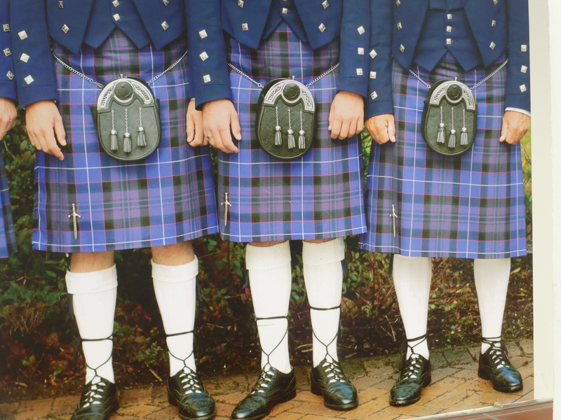 human body part, checked pattern, wearing, kilt, body part, human leg, fashion, skirts, group of people, leisure activity, clothing, side by side, menswear