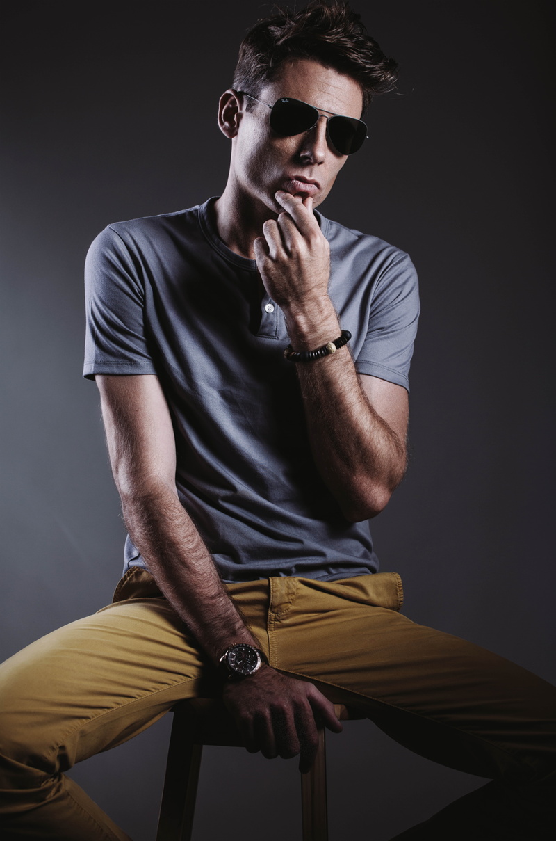 person, 8K, three quarter length, indoors, wooden chair, lifestyles, contemplation, facial expression, wear, portrait, male, front view, gray background