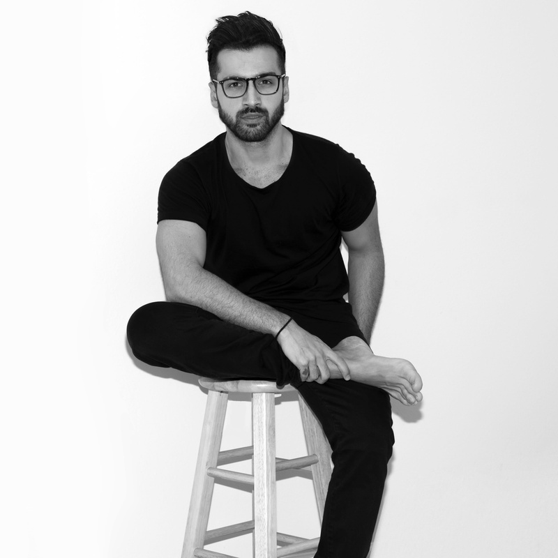 studio shot, cut out, sitting, handsome, barefoot, seating, wooden, cross, 2K, eyeglasses, young adult, facial expression, portrait, model, stool, pensive
