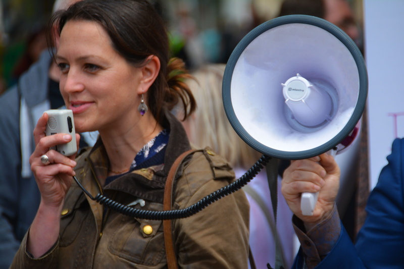 portrait, focus on foreground, technology, mature adult, message, headshot, females, herald, megaphone, brown, public speaker, attention, front view, audio