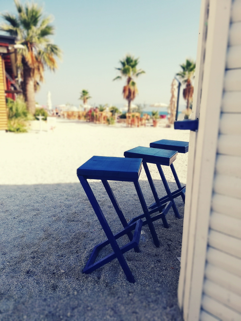seat, focus on foreground, sea, outdoors, day, absence, sky, land, sunlight, table, architecture, therapy for soul, empty, palm tree, shadow, sun, positive thinking