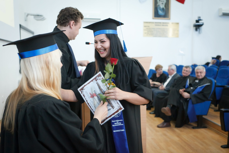 student, room, wearing, achievement, graduation, emotion, academic dress, indoors, academic, success, dress, smiling, certificate, rose, graduation gown