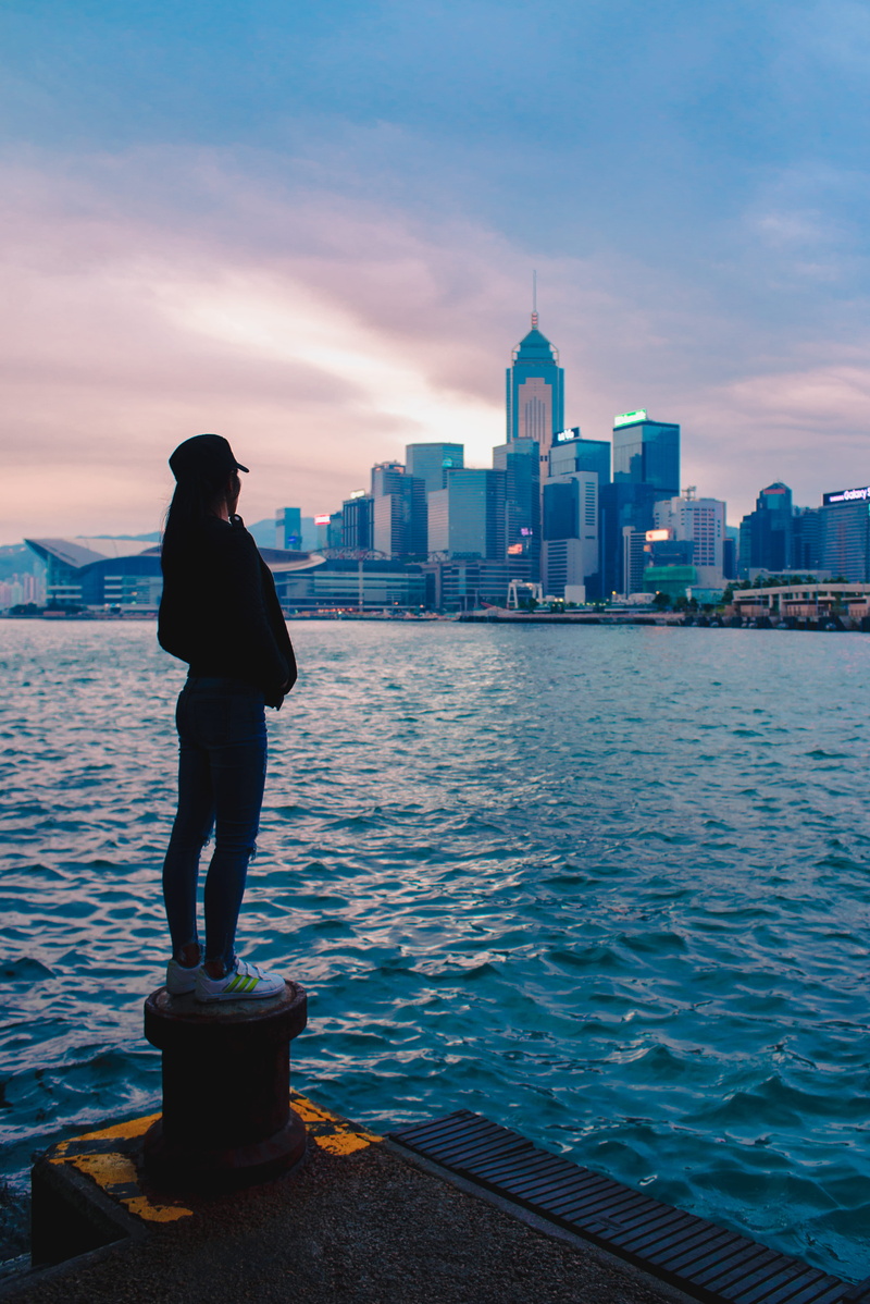 bay, lifestyles, skyscraper, tower, built structure, leisure activity, rear view, sea, buildings, woman, background, black, sky, tall - high, spool, overlooking