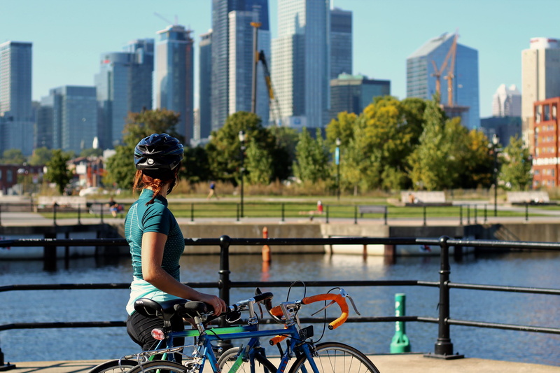 lifestyles, office building exterior, real people, railing, nature, riding, city, mode of transportation, skyline, architecture, helmet, holding, leisure activity