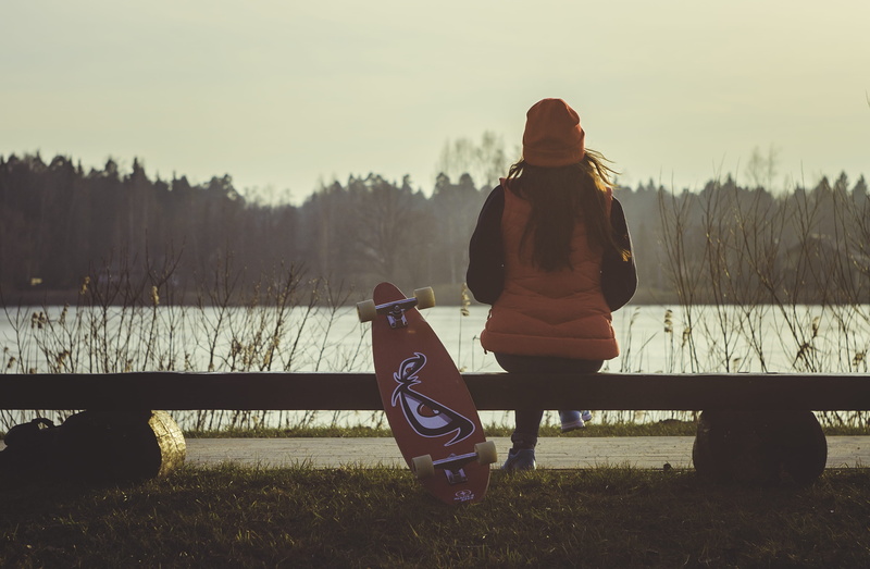 woman in red, lake, tree, caucasian Ethnicity, seat, one woman only, rear view, color Image, skateboard, real people, lifestyles, bag, park bench, looking