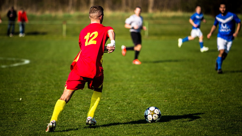 gameplay, football boots, clothing, grass, soccer player, teamwork, soccer team, kicker, football, dress, sports uniform, duel, fire doors, sport, sports ground