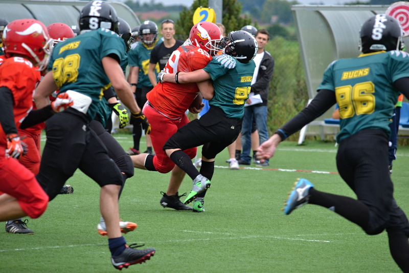 real people, knockdown, day, helmet, group of people, athlete, sport, sportsman, stadium, motion, stop the player with the ball, sports equipment, football