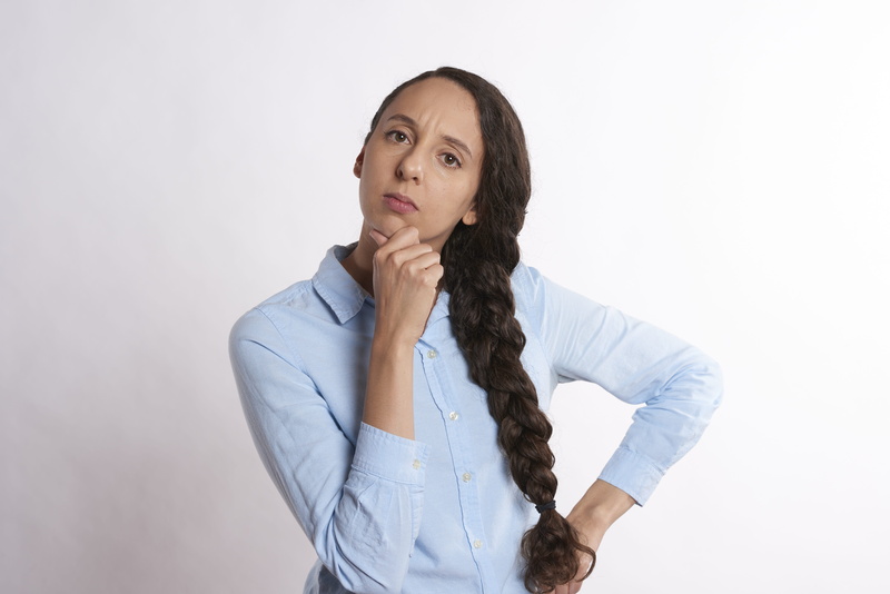 long hair, uncertainty, casual clothing, white background, successful, contemplation, success, adult, office, standing, beautiful woman, person, indoors
