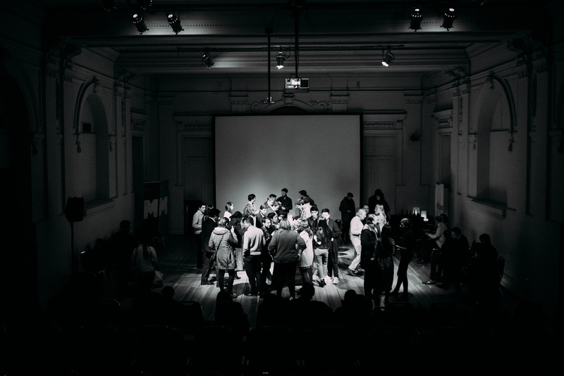 arts culture and entertainment, art, adult, leisure activity, architecture, illuminated, crowd, sitting, indoors, national prize, stage, real people, men