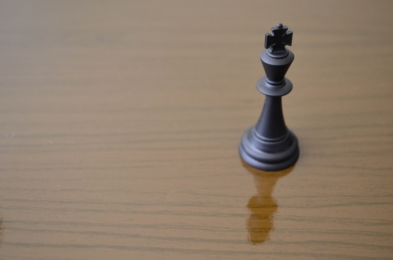 sheikh, table, indoors, strategy, copy space, move, king, king - chess piece, advance, wood grain, shadow, win, piece, intelligence, board, leisure games