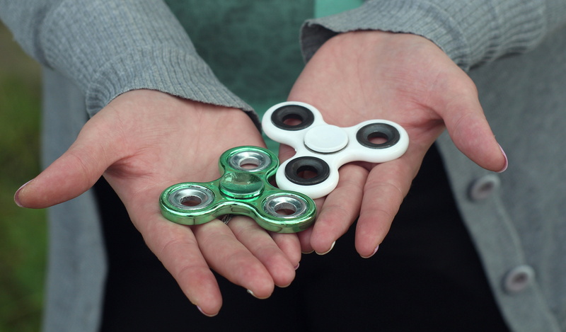 figet spinner, popular, day, midsection, spinner, hyperactivity, play, 4K, one person, viral, fidget, hand, children, metal, high angle view, finger, banned in school