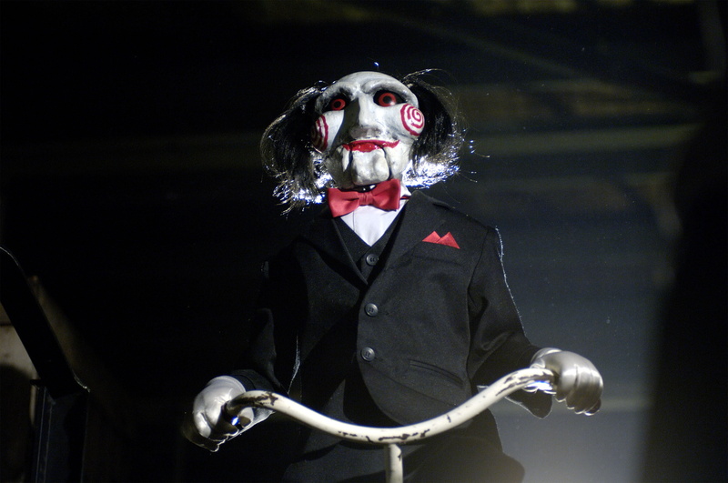 Movie, bicycle, dark, fun, doll, black background, one Person, adult, halloween, indoors, performance, human body part, dressing up, caucasian Ethnicity