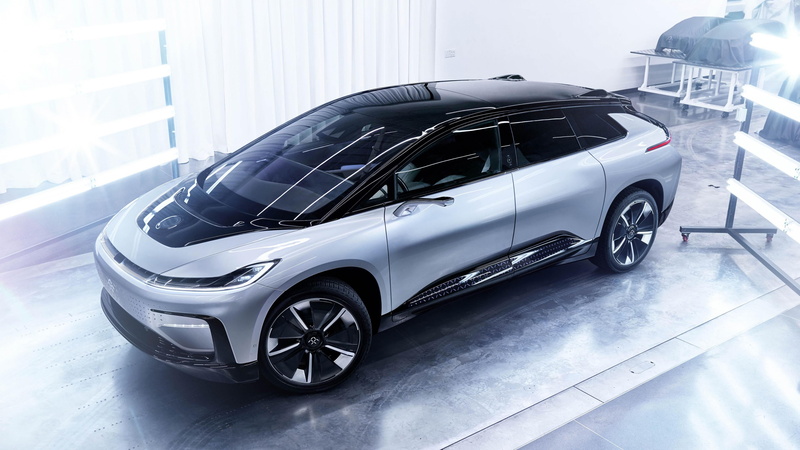 indoors, focus on foreground, transportation, reflection, land vehicle, faraday future, high-tech, modern, black color, mode of transportation, future