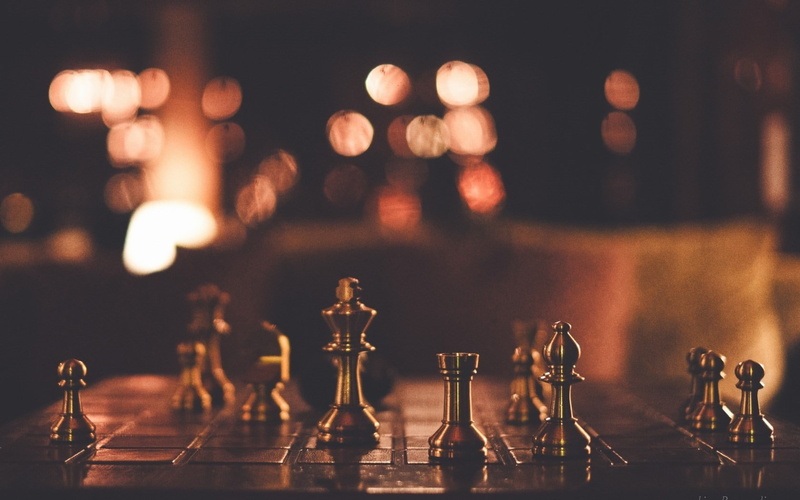 glass - material, business, strategy, food and drink, chess piece, illuminated, gold, high, arrangement, indoors, board, still life, chess board, bar counter