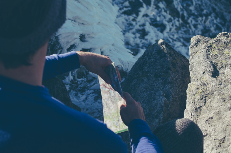 sunlight, activity, exercise, navigation, one person, nature, sitting, holding, paper, piece, rock, mountains, directions, men, person, fitness, adults only