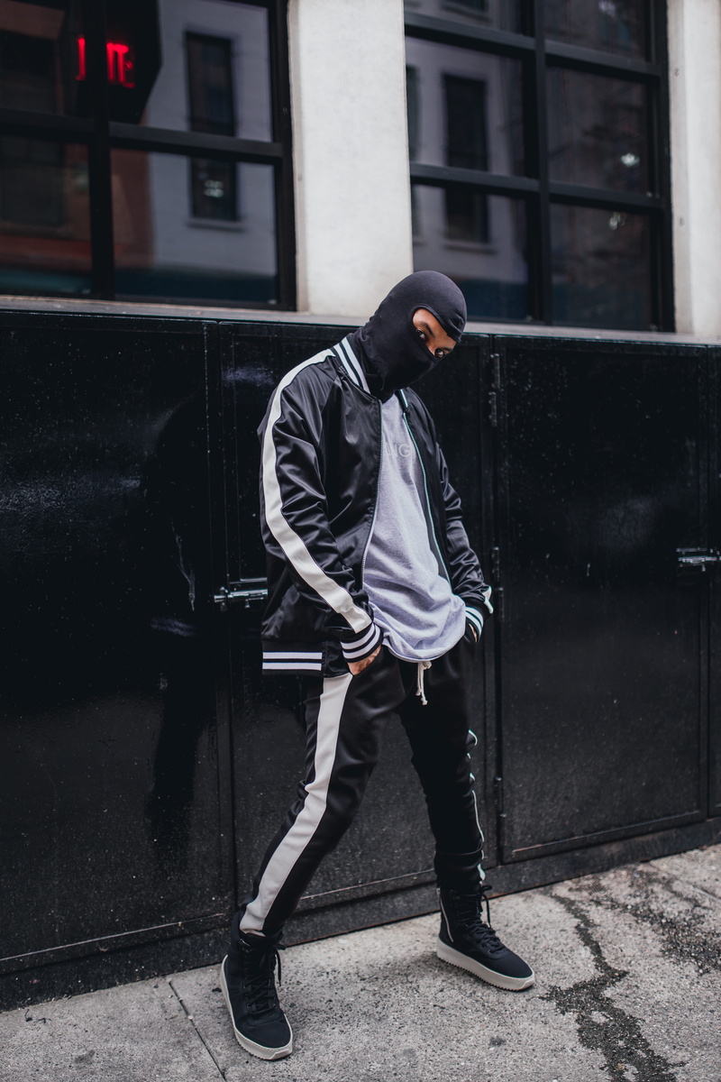 standing, young adult, man, real people, fashion, outdoors, shirt, looking away, black, lifestyles, day, cabinet, metal, young men, city, wears, leisure activity