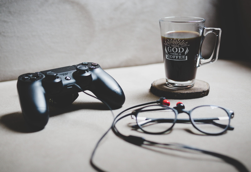 time, food and drink, controller, headphones, clear, glasses, table, refreshment, cup, game, close-up, coffee, listening, black, gaming, dualshock, cable